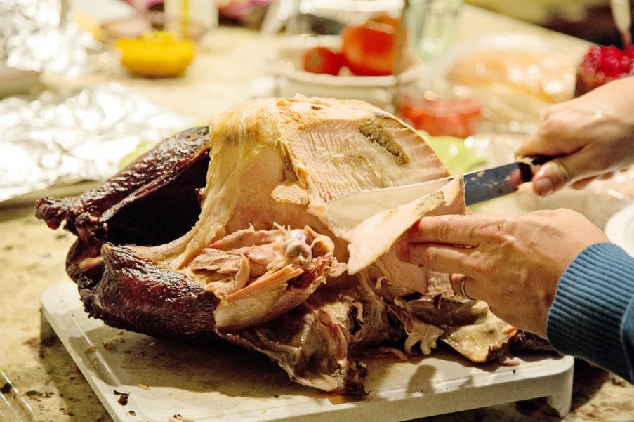 Slicing a turkey using a plain edge knife.